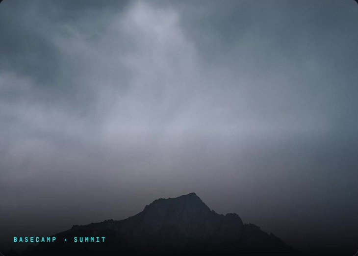 A mountain summit rising through cloud